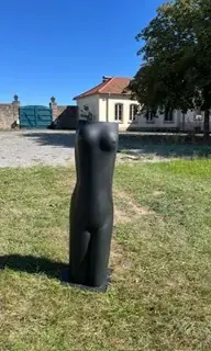 Black female torso on a pedestal outdoors