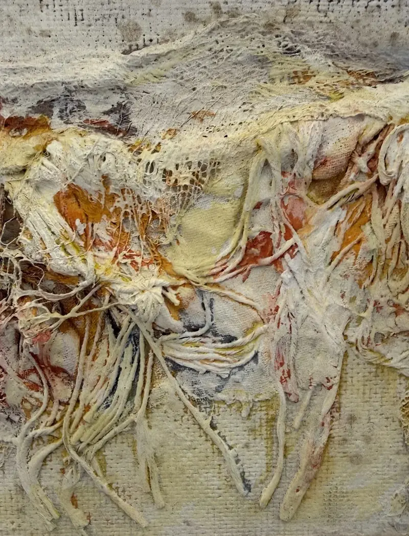 Detail of a relief painting by Johnson: thick, fibrous layers of paint in white, ocher and red