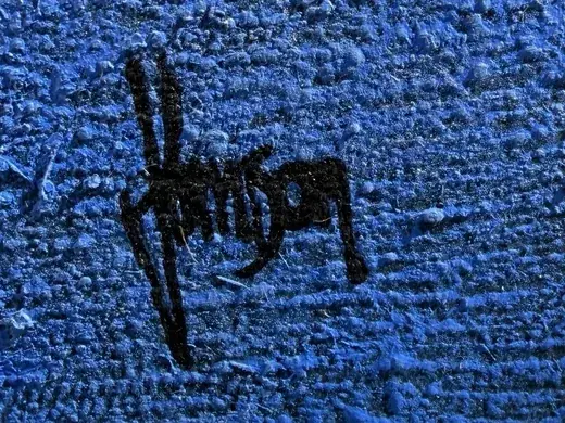 Detail: the signature “Johnson” in black on the rough blue ground of the painting “Super Blue Circle Earth”